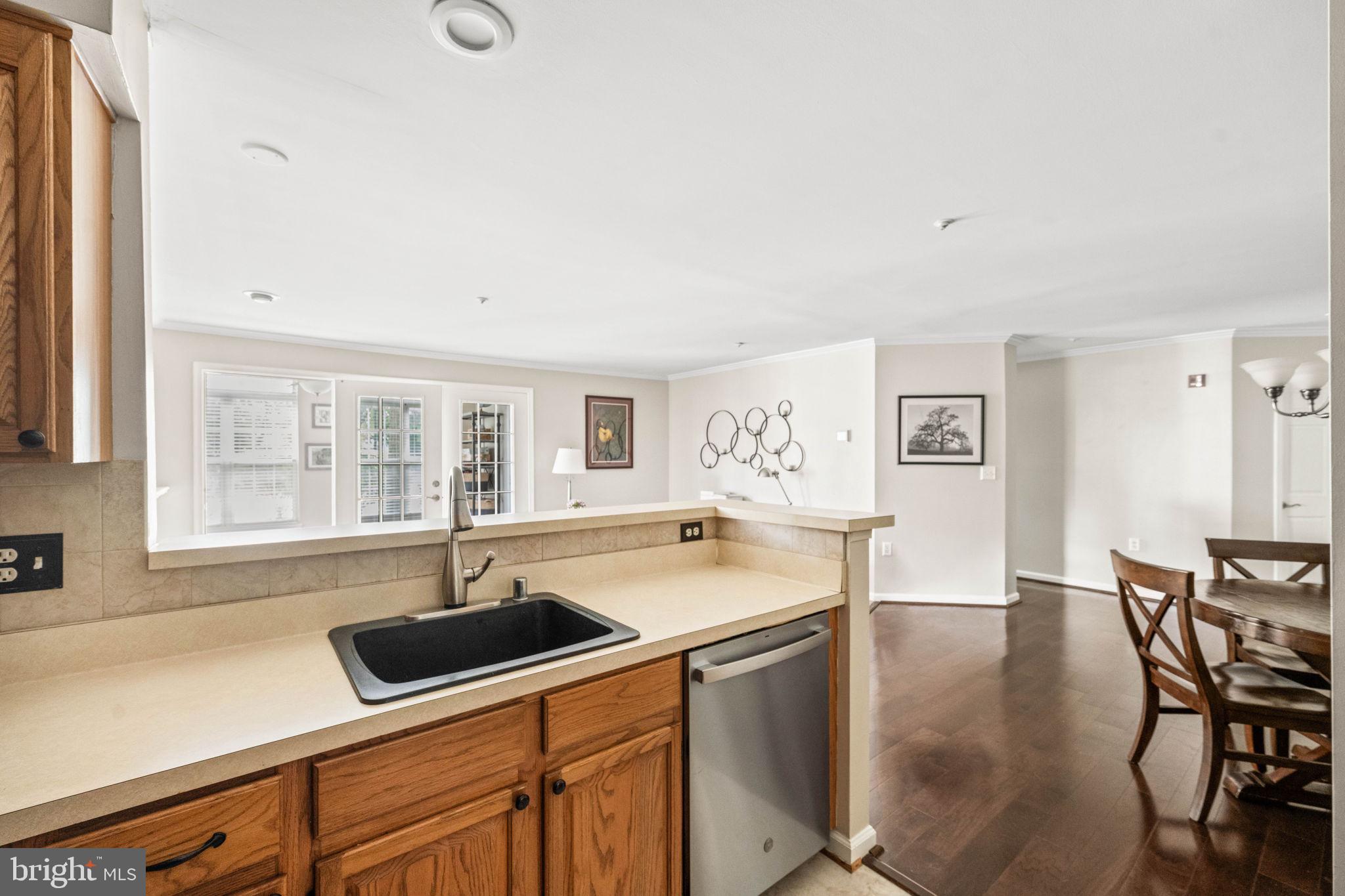 6602 Thackwell Way, Unit C Alexandria, VA 22315 - Photo 18 of 54 a kitchen with a sink a counter and chairs