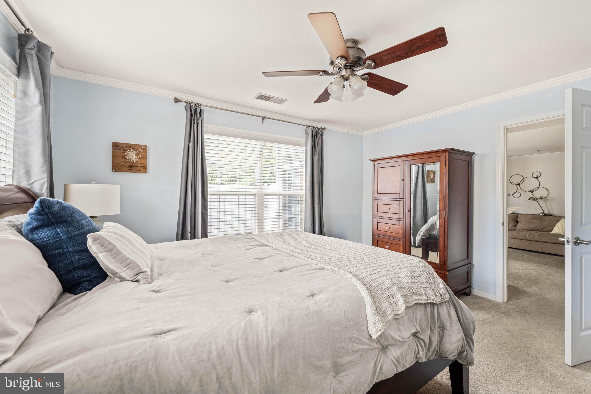 6602 Thackwell Way, Unit C Alexandria, VA 22315 - Photo 25 of 54 a bedroom with a large bed and a ceiling fan