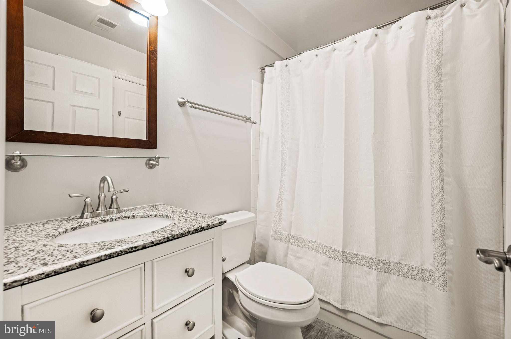 6602 Thackwell Way, Unit C Alexandria, VA 22315 - Photo 32 of 54 a bathroom with a granite countertop sink and a mirror