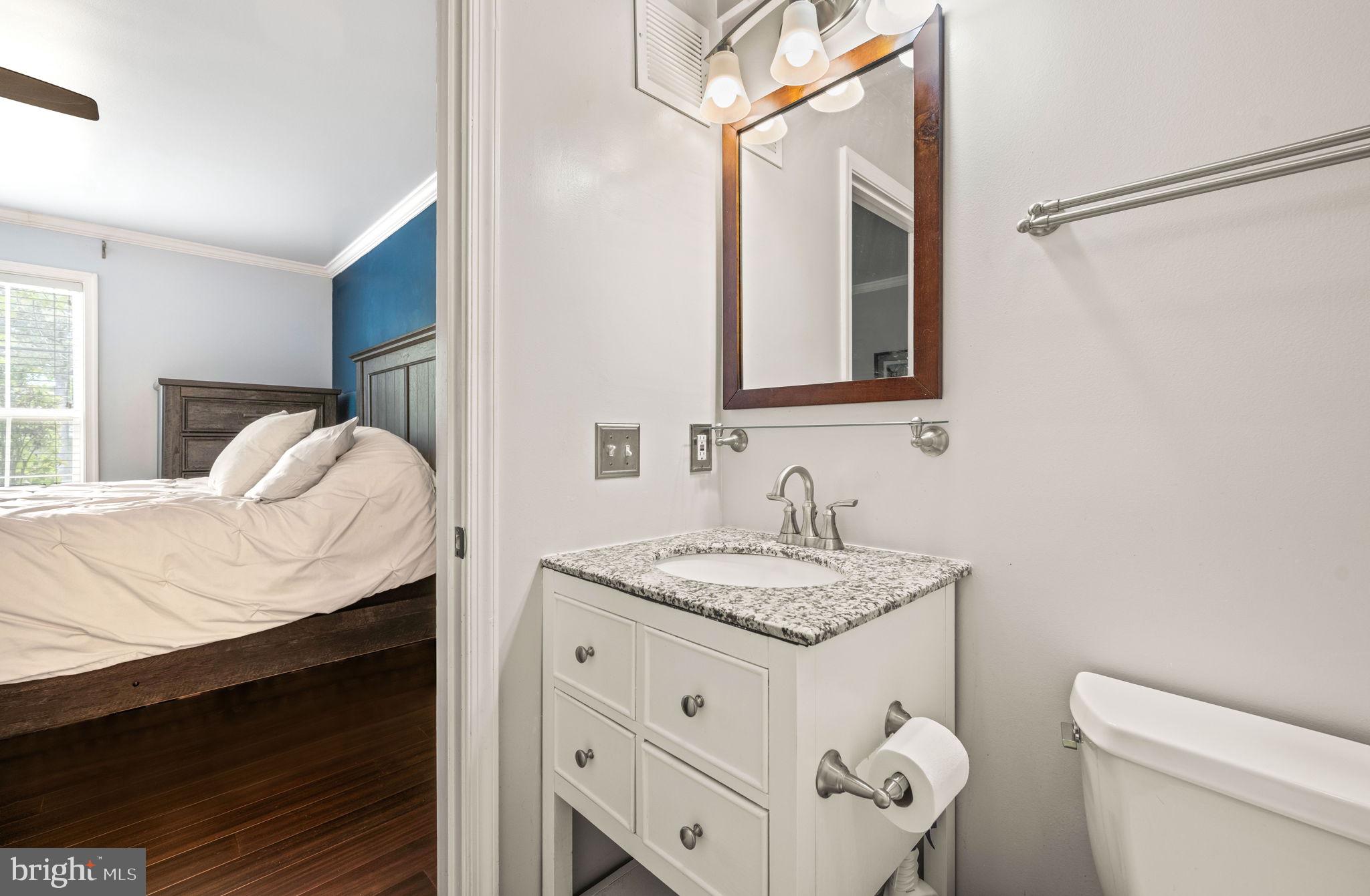 6602 Thackwell Way, Unit C Alexandria, VA 22315 - Photo 34 of 54 a bathroom with a granite countertop sink vanity mirror and toilet