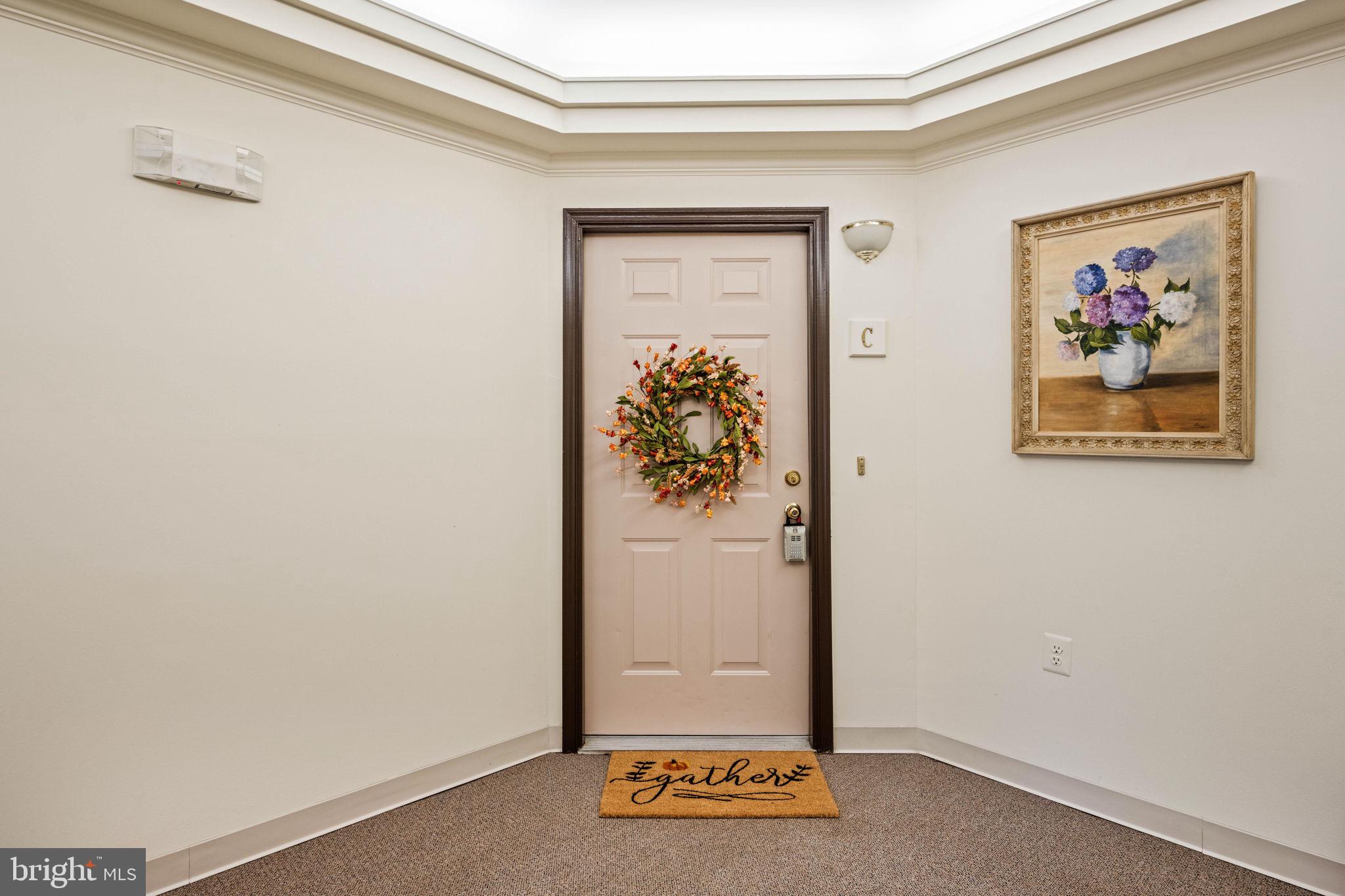 6602 Thackwell Way, Unit C Alexandria, VA 22315 - Photo 4 of 54 a view of a hallway with paintings on the wall