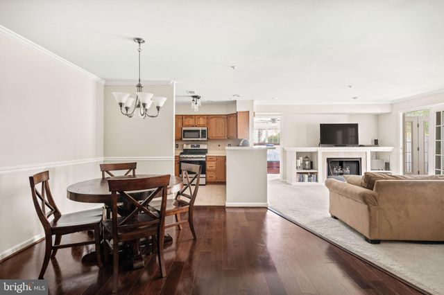 a view of a dining room with furniture wooden floor and chandelier