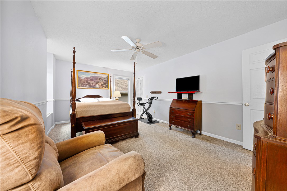 139 Tulip Lane Westminster, SC 29693 - Photo 7 of 37 Comfortable carpeted primary bedroom featuring a ceiling fan and natural light.