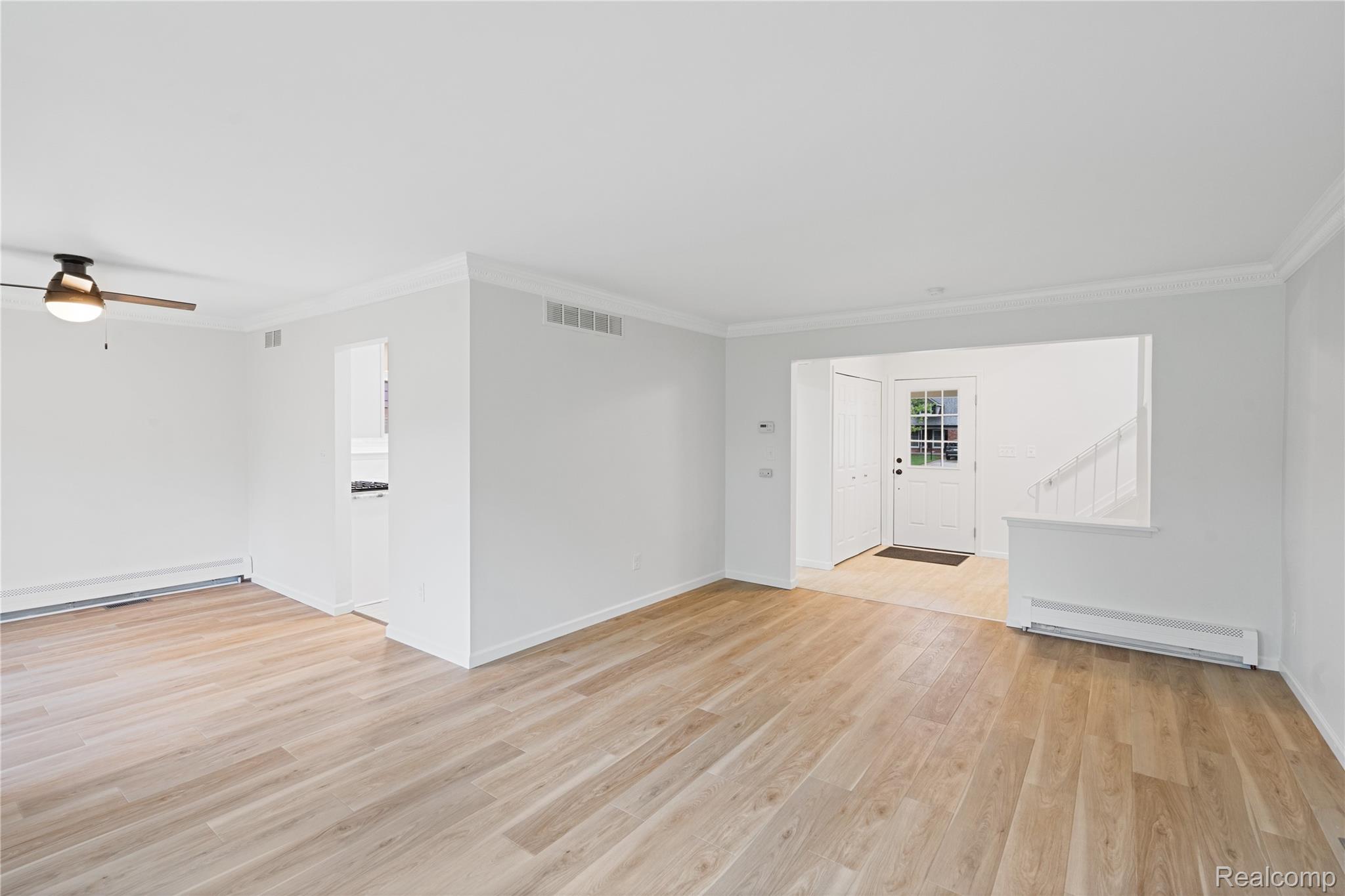 8240 Hampton Road Grosse Ile, MI 48138 - Photo 10 of 33 Spacious room with light wood-finish flooring, white walls, and crown molding