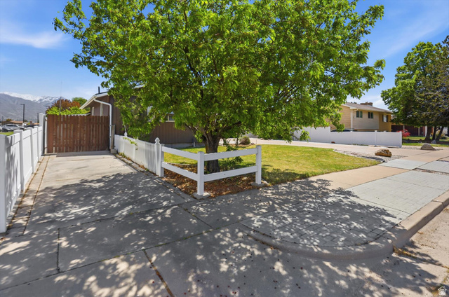 5108 South 2000th Street West Roy, UT 84067 - Photo 47 of 61 View of front of property featuring a fenced front yard and driveway with RV Parking