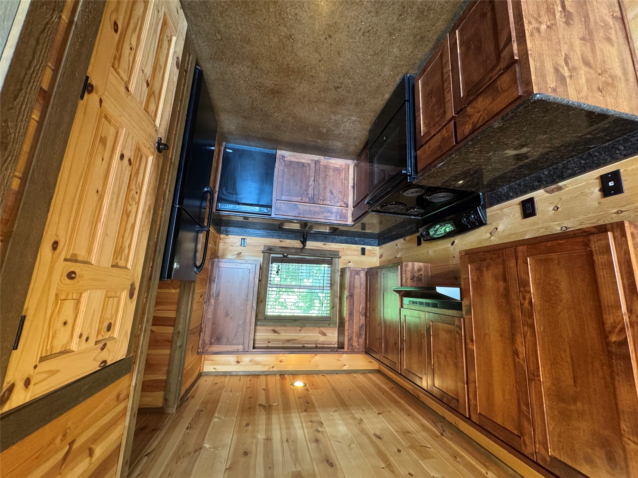 305 Rocking M Road, Unit 2 Kyle, TX 78640 - Photo 5 of 14 a kitchen with granite countertop a sink a stove top oven a cabinetry and a counter space