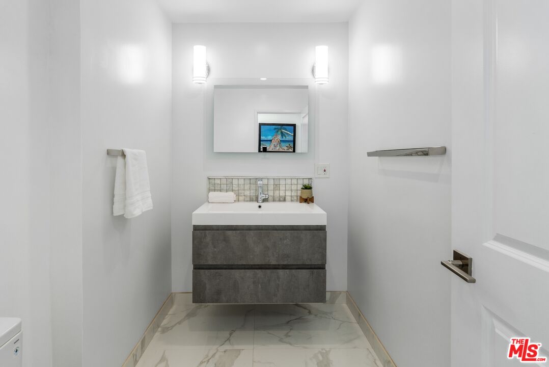 3806 Ocean Front Walk, Unit 2 Marina del Rey, CA 90292 - Photo 13 of 26 a bathroom with a sink and a mirror