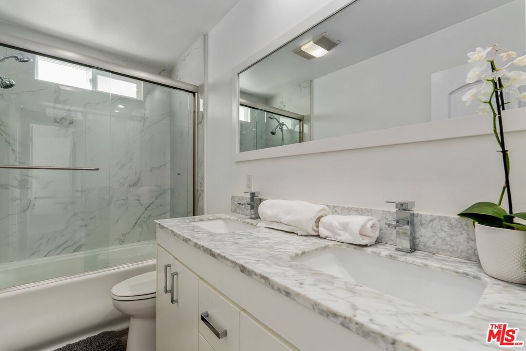 3806 Ocean Front Walk, Unit 2 Marina del Rey, CA 90292 - Photo 15 of 26 a bathroom with a granite countertop sink toilet and shower