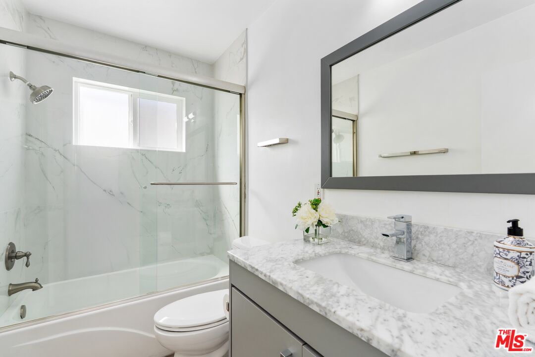 3806 Ocean Front Walk, Unit 2 Marina del Rey, CA 90292 - Photo 17 of 26 a bathroom with a granite countertop sink toilet and shower