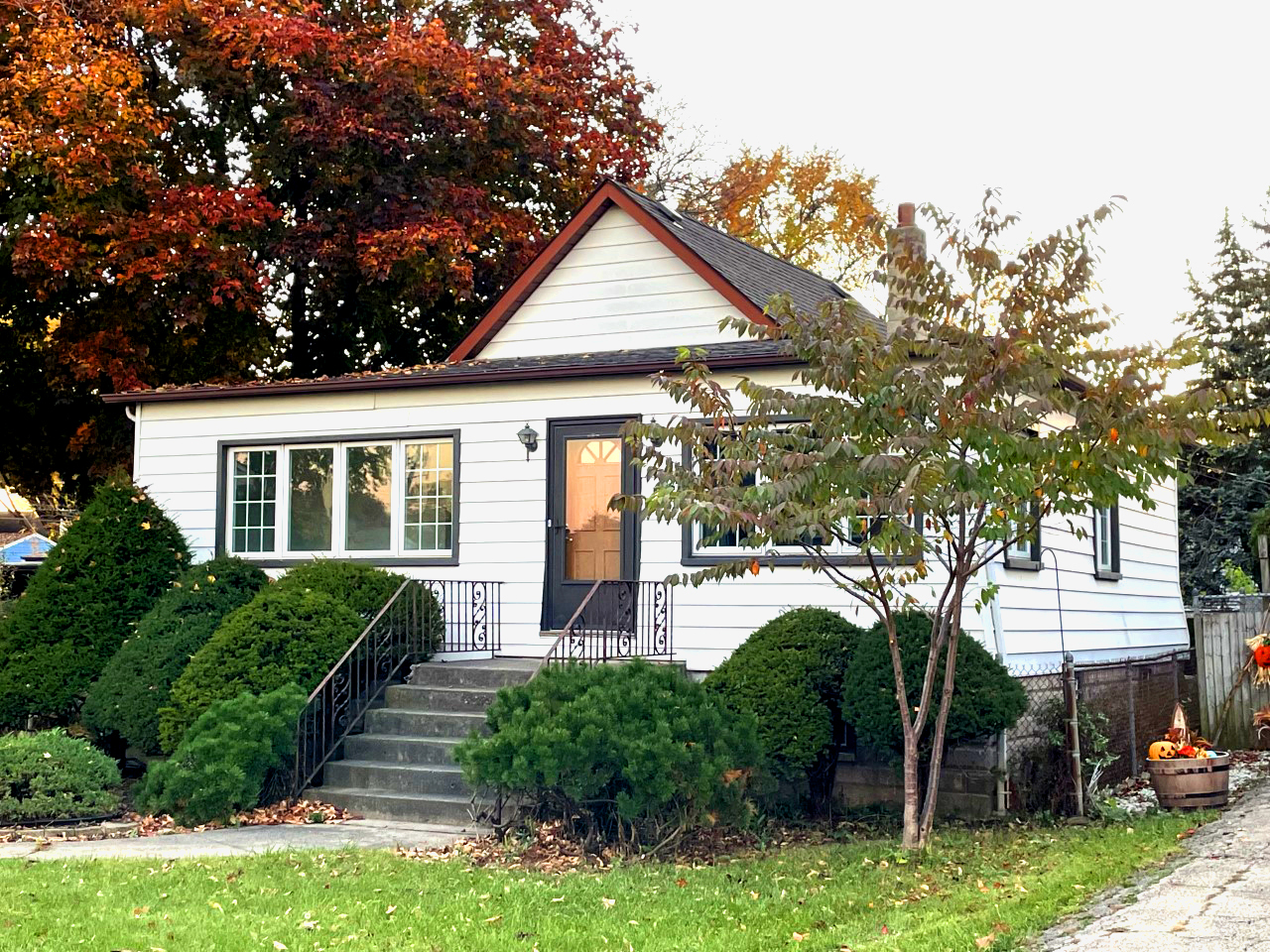 4332 Ruby Street Schiller Park, IL 60176 - Photo 2 of 2 a front view of a house with a yard and potted plants
