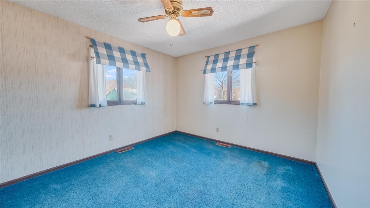 1504 Harrington Drive Champaign, IL 61821 - Photo 18 of 40 an empty room with windows and fan