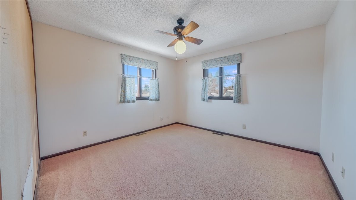 1504 Harrington Drive Champaign, IL 61821 - Photo 20 of 40 an empty room with ceiling fan and window