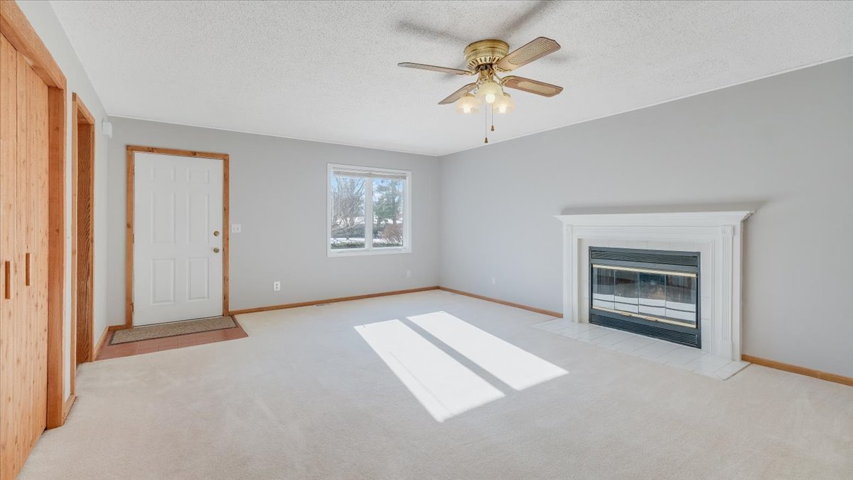 1504 Harrington Drive Champaign, IL 61821 - Photo 2 of 40 an empty room with windows and chandelier fan