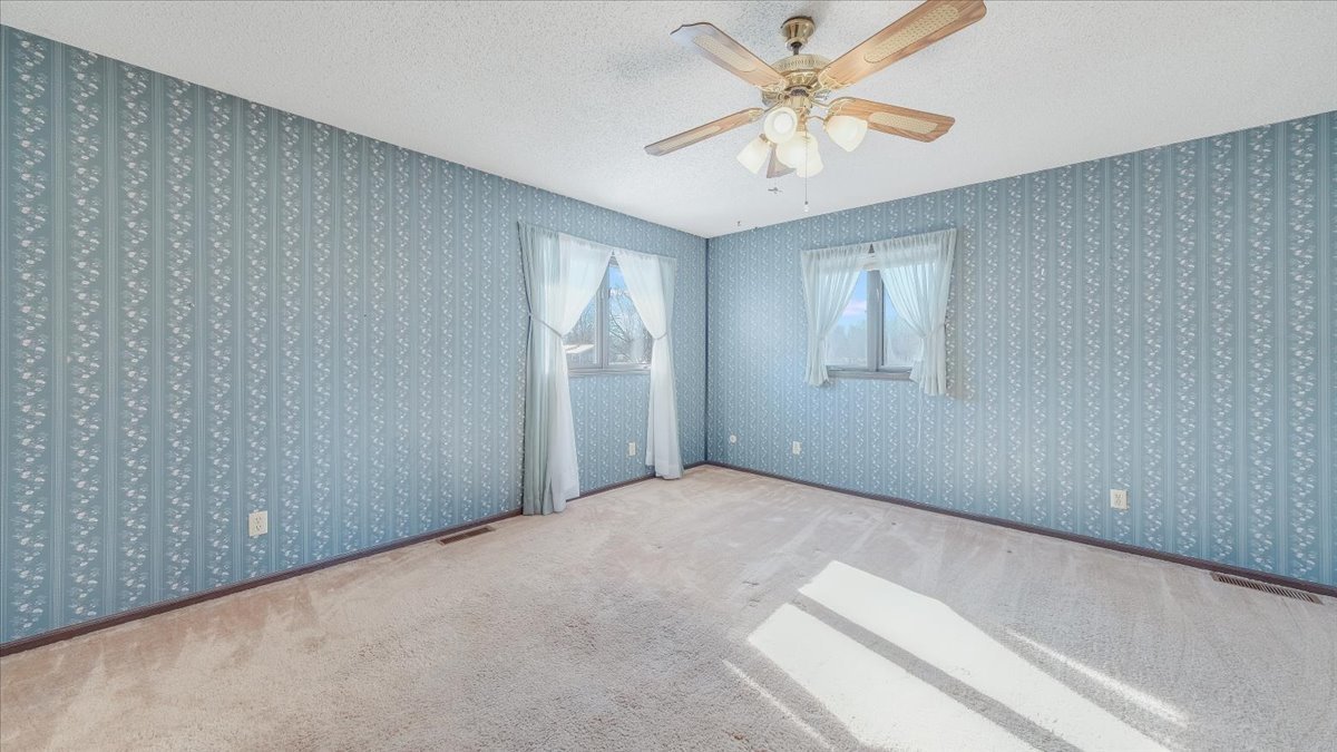 1504 Harrington Drive Champaign, IL 61821 - Photo 25 of 40 an empty room with windows and fan