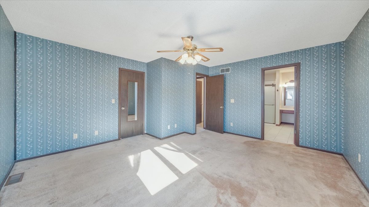 1504 Harrington Drive Champaign, IL 61821 - Photo 26 of 40 a view of a big room with chandelier fan and windows