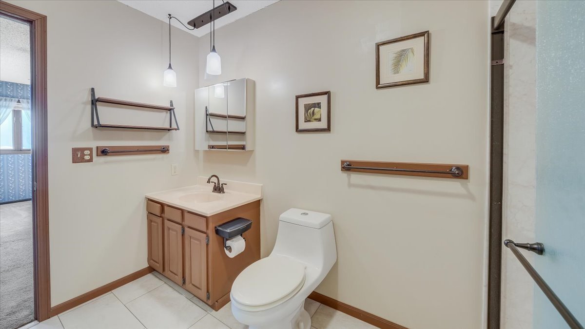 1504 Harrington Drive Champaign, IL 61821 - Photo 31 of 40 a bathroom with a toilet a sink and a mirror