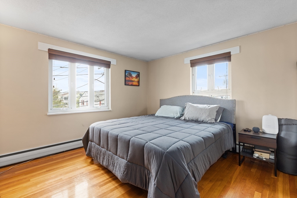 145 Warren Street, Unit 8 Watertown, MA 02472 - Photo 7 of 10 a bedroom with a bed and a window