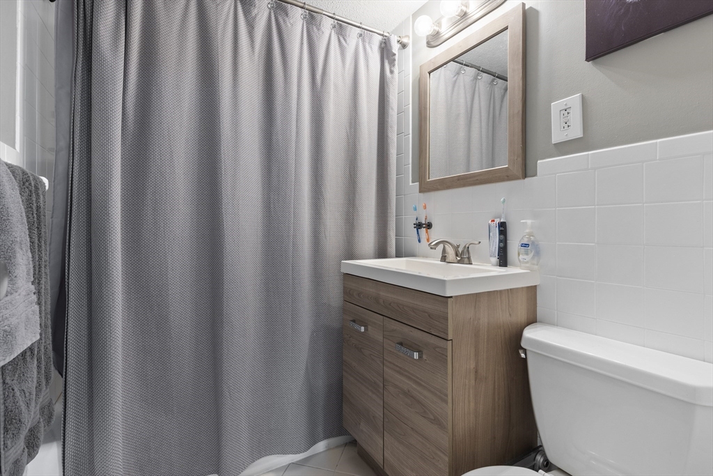 145 Warren Street, Unit 8 Watertown, MA 02472 - Photo 9 of 10 a bathroom with a sink toilet and shower