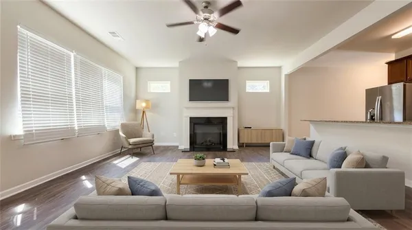 a living room with furniture a fireplace and a flat screen tv