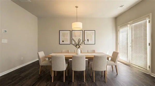 a view of a dining room with furniture window and wooden floor