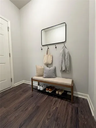 a view of a room with wooden floor and lounge chair