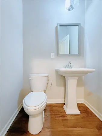 a white toilet sitting next to a bathroom sink