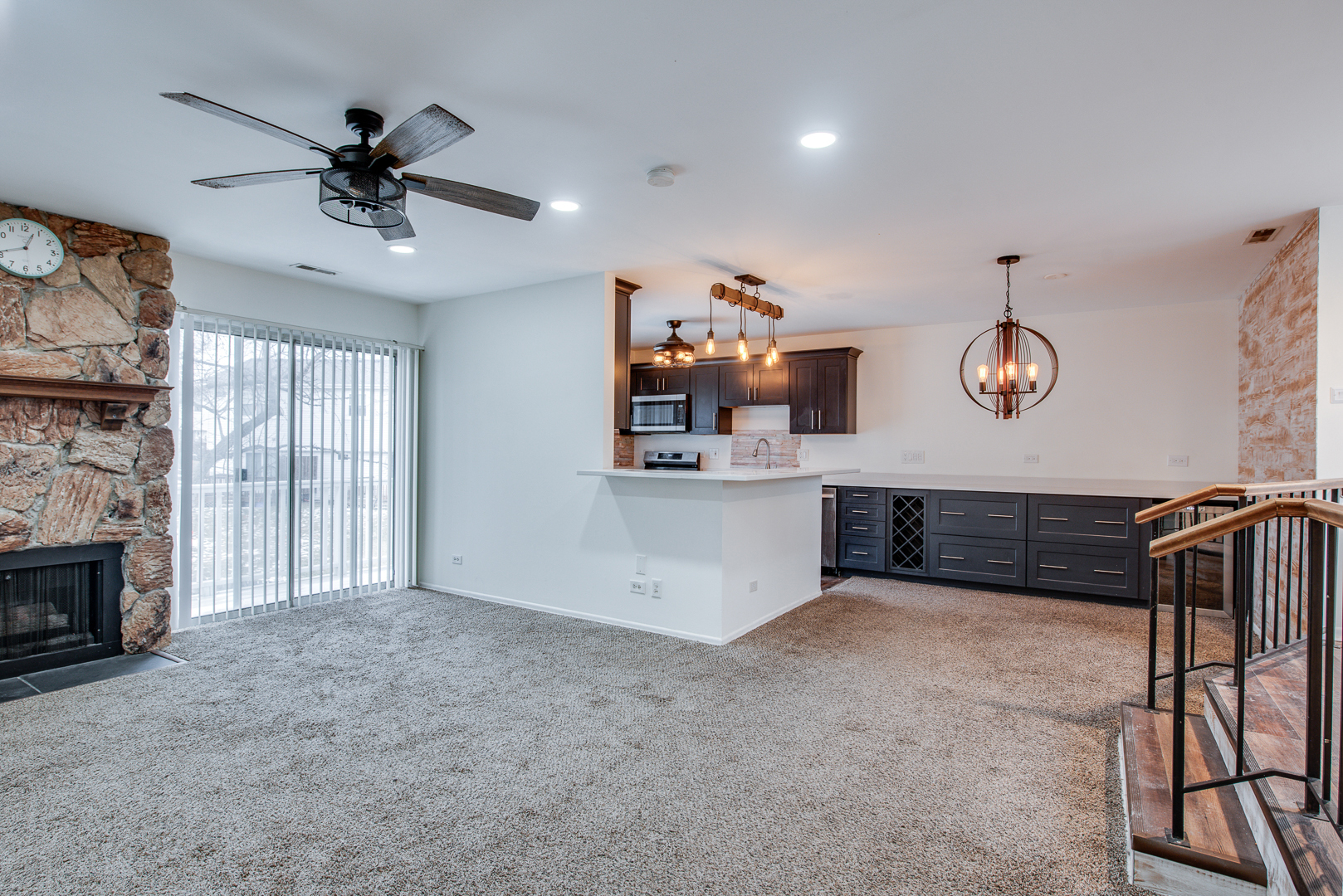 340 Springlake Lane, Unit D Aurora, IL 60504 - Photo 3 of 15 a view of a livingroom with a fireplace furniture a ceiling fan and a window