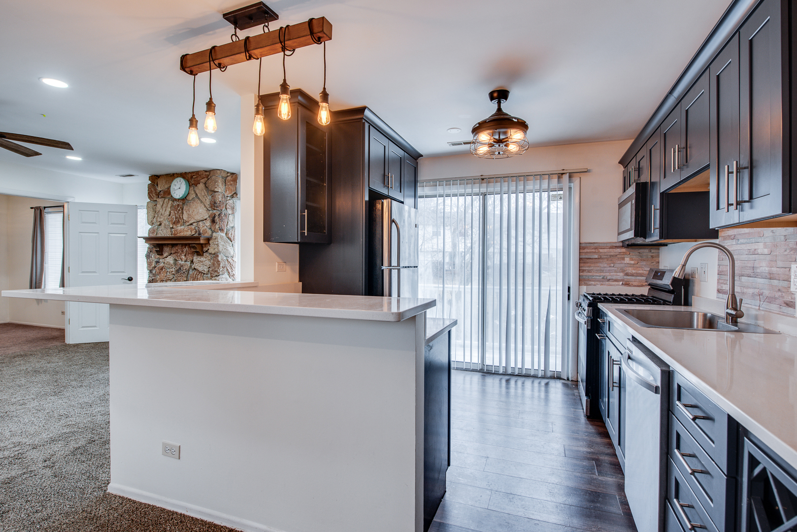 340 Springlake Lane, Unit D Aurora, IL 60504 - Photo 7 of 15 a kitchen with stainless steel appliances a sink stove and refrigerator