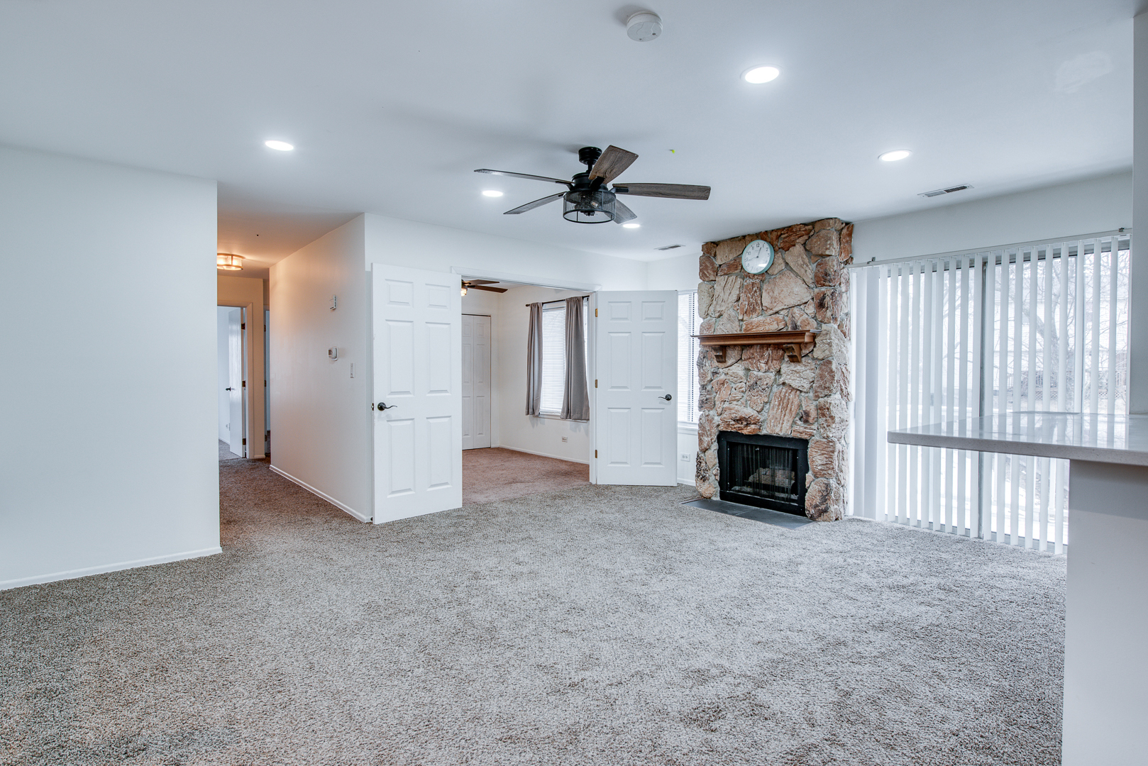 340 Springlake Lane, Unit D Aurora, IL 60504 - Photo 9 of 15 an empty room with fireplace and windows