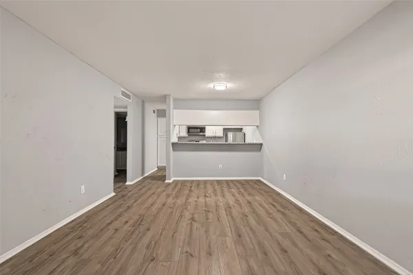 a view of a kitchen with wooden floor