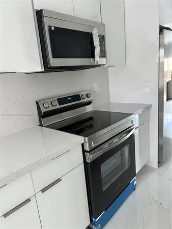a stove top oven sitting inside of a kitchen