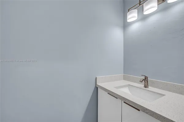 a bathroom with a sink and vanity