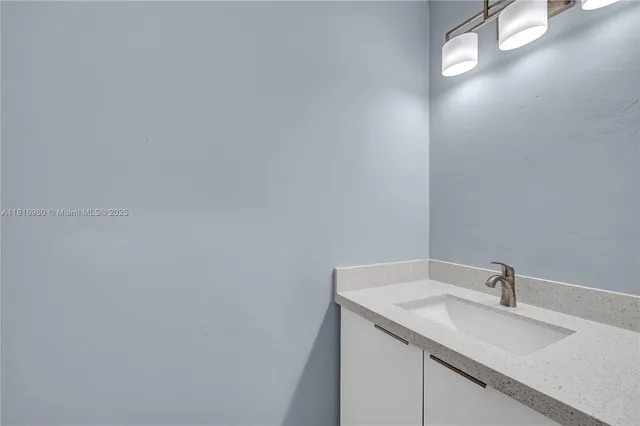 a bathroom with a sink and vanity