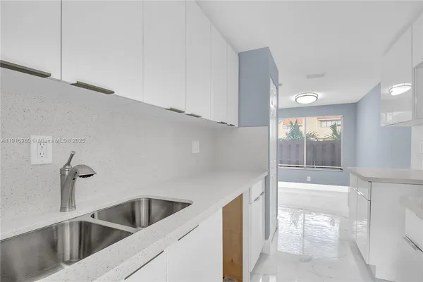 a view white a sink and dishwasher with kitchen view