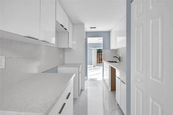 a view of a kitchen from the hallway