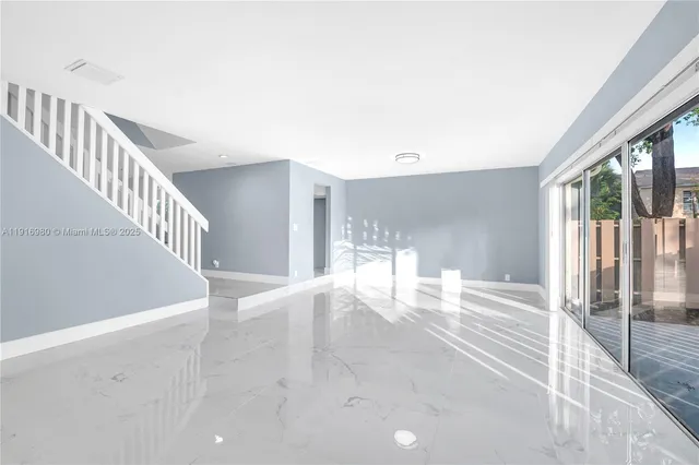 a view of an entryway with wooden floor