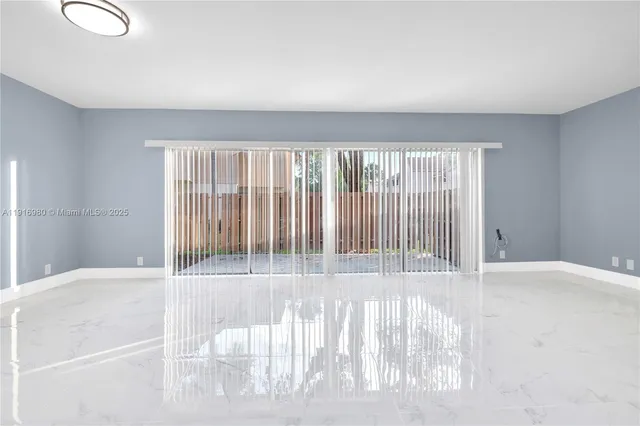 a view of wooden floor and window in a room
