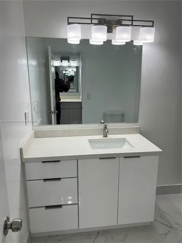 a bathroom with a sink and a mirror