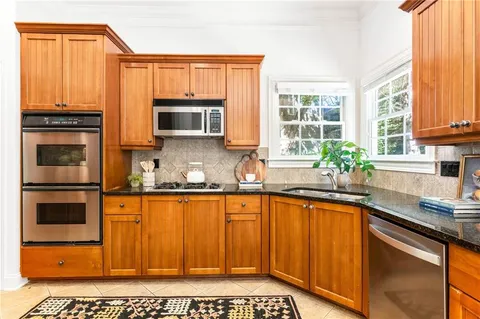 a kitchen with stainless steel appliances a stove a sink and a microwave