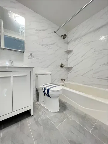 a bathroom with a toilet a sink and bathtub