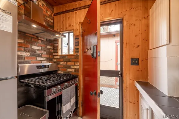 a kitchen with stainless steel appliances granite countertop a stove and a refrigerator