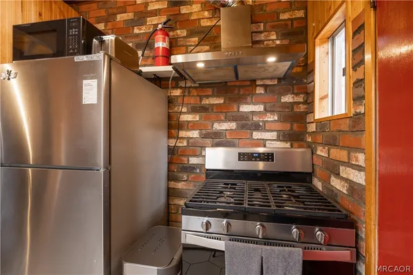 a stove top oven sitting inside of a kitchen