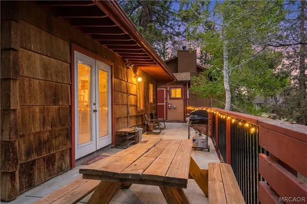 a view of balcony with wooden floor and outdoor seating