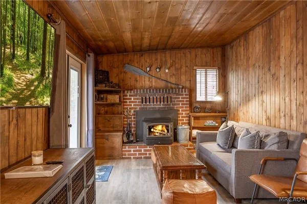 a living room with furniture a fireplace and a window