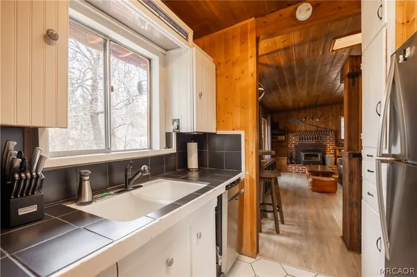 a kitchen with a sink and a refrigerator