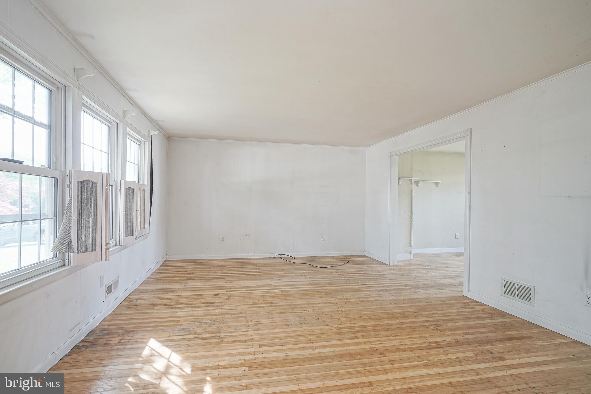 152 Kelly Driver Road Laurel Springs, NJ 08021 - Photo 3 of 30 a view of an empty room with wooden floor and a window