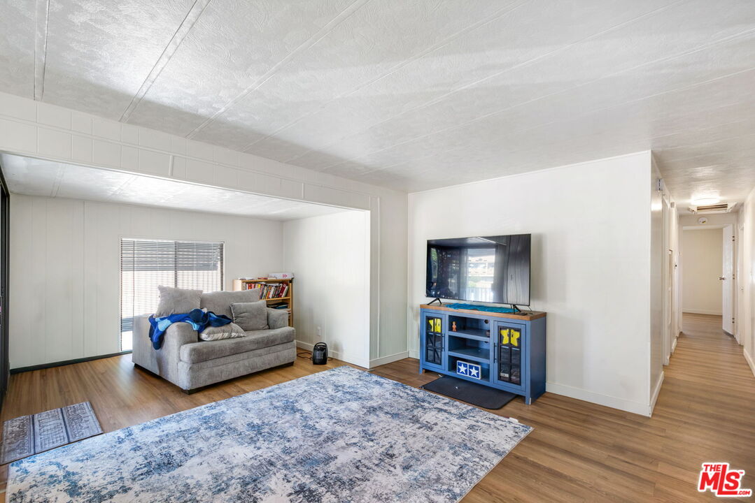 1502 East Carson Street, Unit 5 Carson, CA 90745 - Photo 2 of 10 a living room with furniture and a flat screen tv