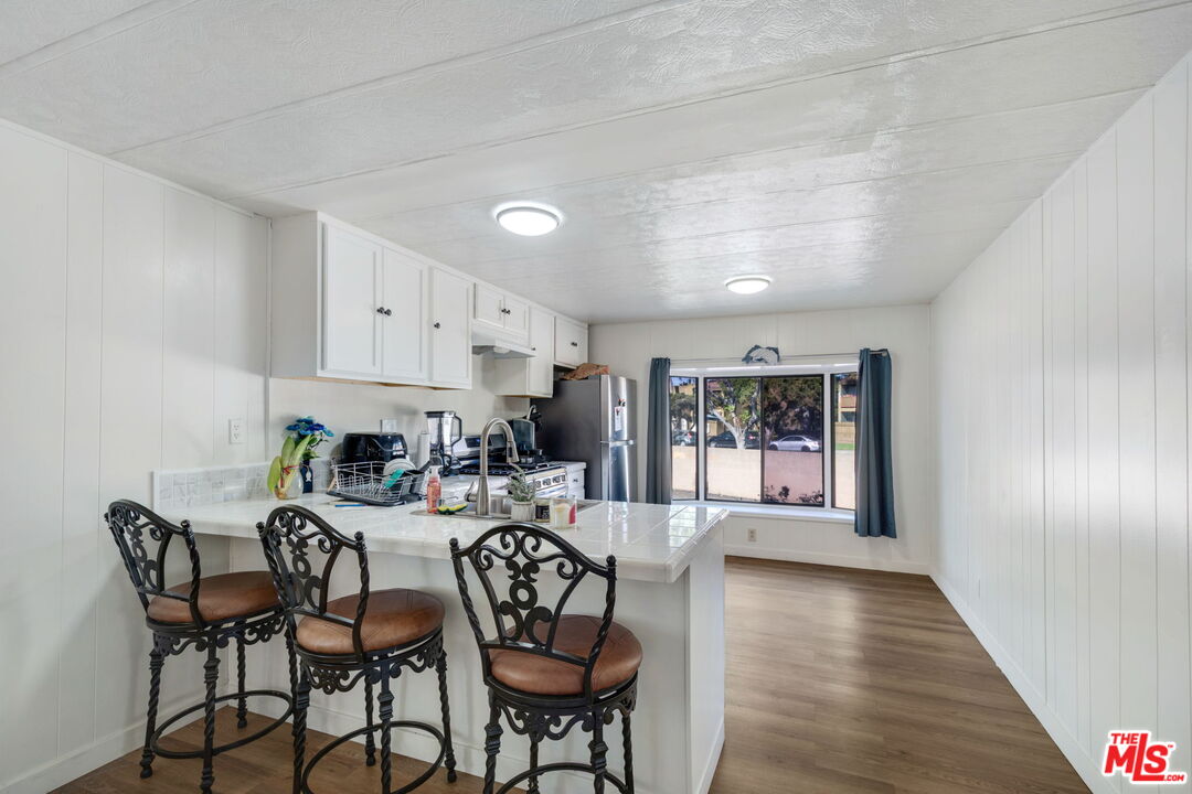 1502 East Carson Street, Unit 5 Carson, CA 90745 - Photo 4 of 10 a view of a dining room with furniture window and wooden floor
