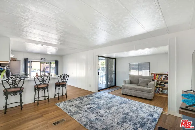 a living room with furniture and a dining table