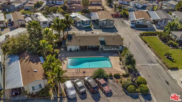 an aerial view of a house with swimming pool outdoor seating and yard